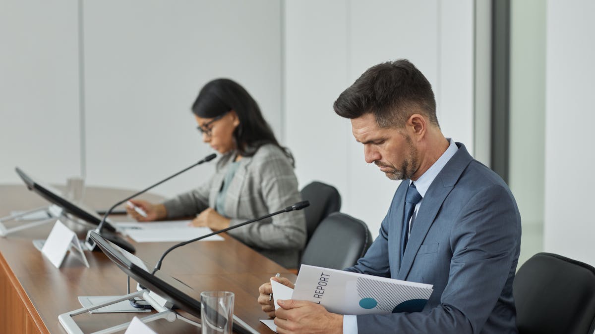 Diverse non-profit board reviewing financial documents at a conference table